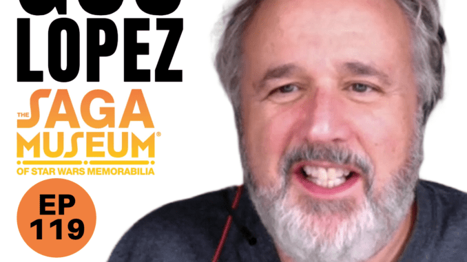 Guz Lopez smiling next to the Saga Museum Logo